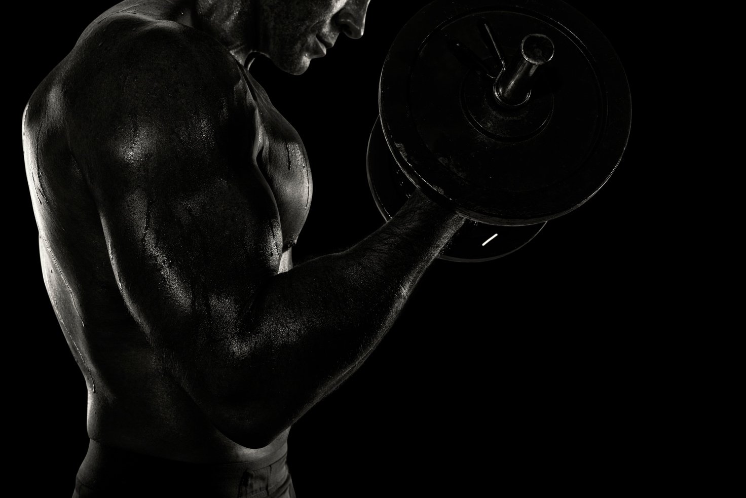 Athletic Man Training Biceps at the Gym. Black and White Effect